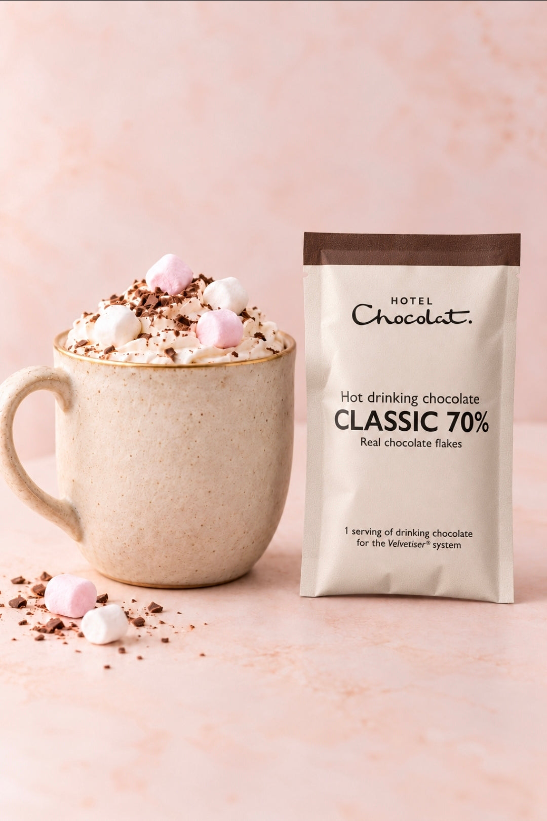 Hotel Chocolat Classic 70 percent drinking chocolate sachet beside a styled hot chocolate; mug and toppings are not included.