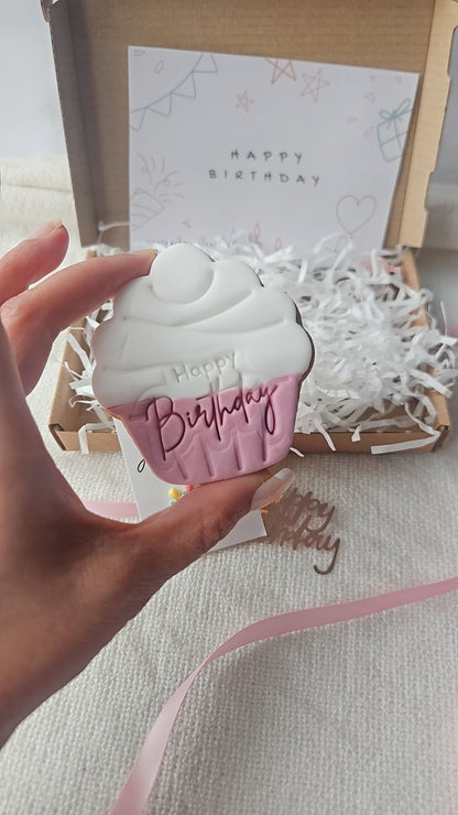 Pink and white cupcake-shaped Happy Birthday iced biscuit