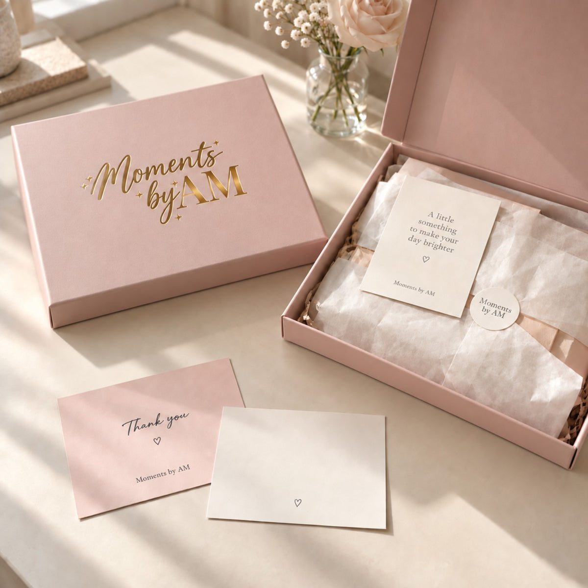 Moments by AM pink gift box packaging with tissue paper and message cards