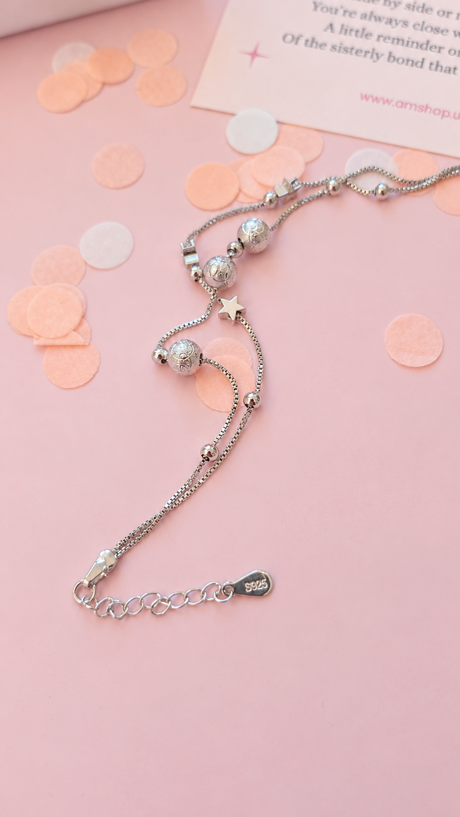 Close up of silver Sister bracelet with star and bead details