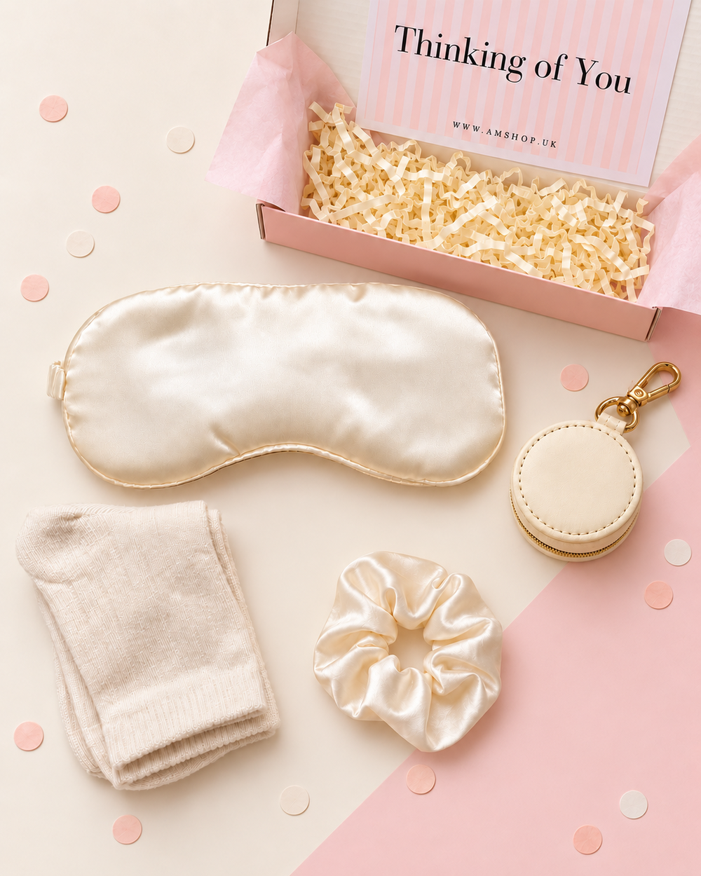 Thinking of You gift box contents arranged on a soft pink background